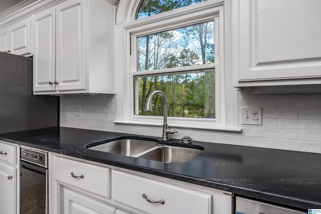 4049 Water Willow Ln, Hoover, AL 35244 - kitchen featuring white cabinets, a sink, and decorative backsplash