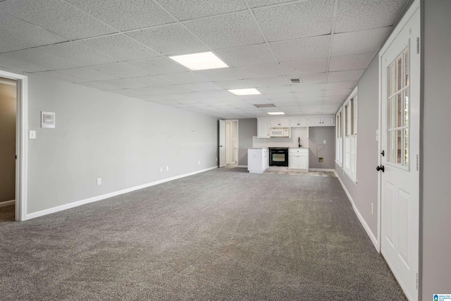 4049 Water Willow Ln, Hoover, AL 35244 - unfurnished living room featuring a paneled ceiling, dark colored carpet, and baseboards