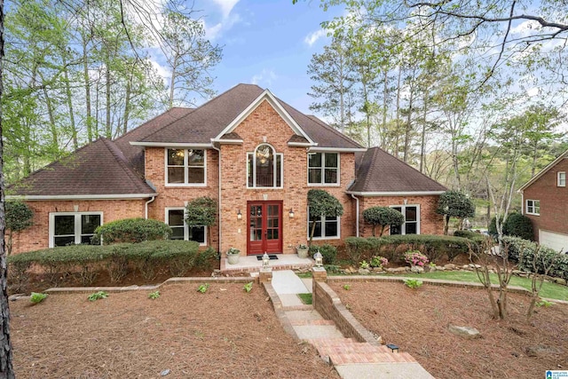 4049 Water Willow Ln, Hoover, AL 35244 - view of front of house with french doors, a shingled roof, and brick siding