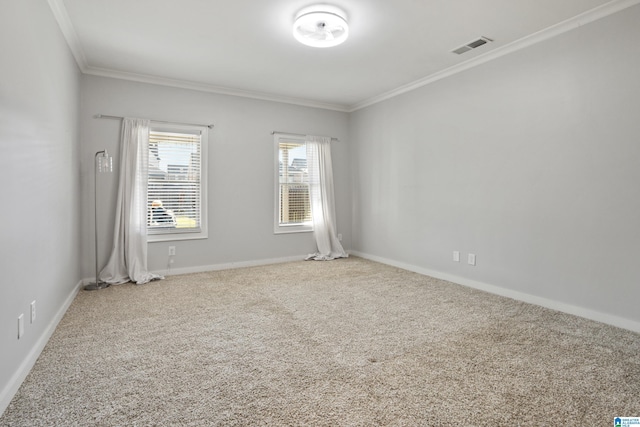 empty room with crown molding, carpet floors, baseboards, and visible vents