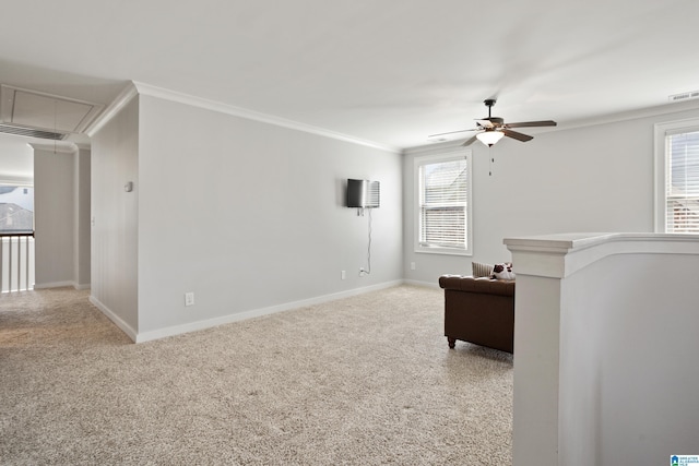 living area featuring crown molding, ceiling fan, visible vents, attic access, and baseboards