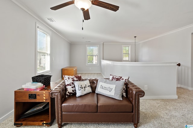 sitting room featuring crown molding, baseboards, a ceiling fan, and an upstairs landing