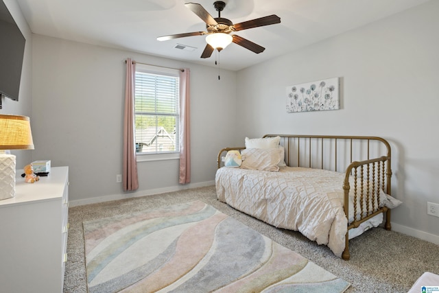 carpeted bedroom with visible vents, baseboards, and ceiling fan