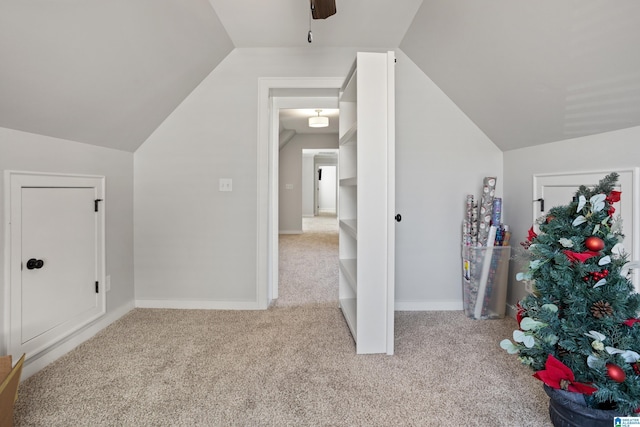 additional living space featuring baseboards, a ceiling fan, lofted ceiling, and carpet floors