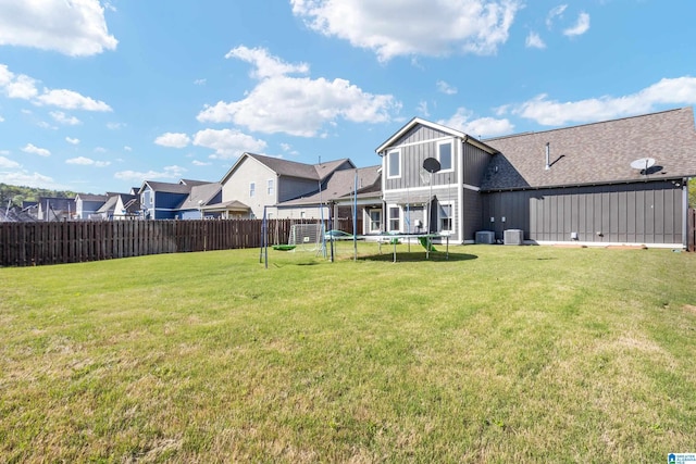 view of yard featuring fence and a trampoline