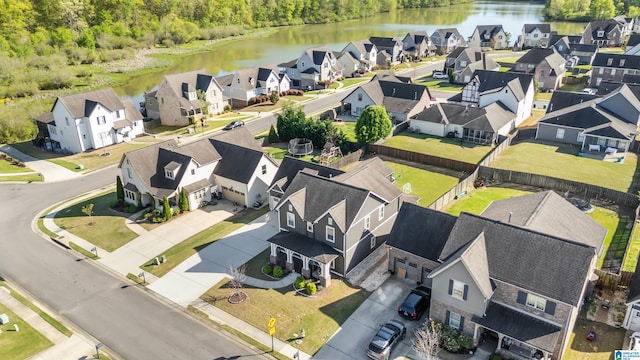 bird's eye view with a water view and a residential view