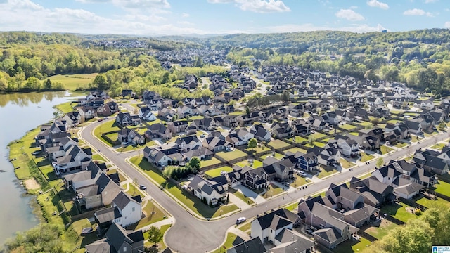 bird's eye view featuring a water view, a residential view, and a forest view