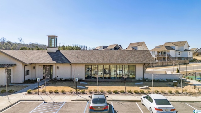 exterior space featuring uncovered parking and stucco siding