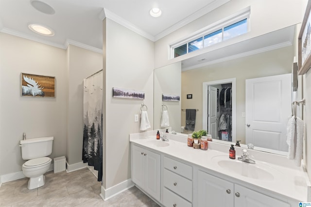bathroom with a sink, toilet, double vanity, and crown molding