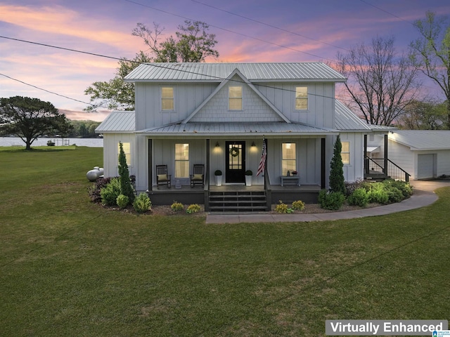 view of front of property with metal roof, a garage, board and batten siding, and a porch