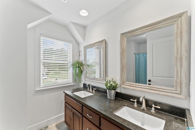 full bath with double vanity, a sink, baseboards, and recessed lighting