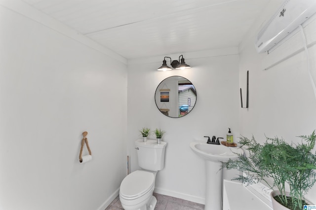 bathroom featuring baseboards, toilet, and tile patterned floors