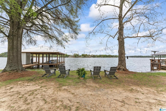 view of dock with boat lift and a water view