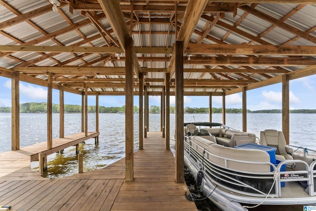 dock area with boat lift and a water view