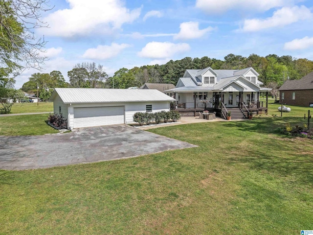 view of front facade featuring a front lawn, driveway, a porch, and metal roof