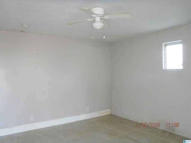 empty room with baseboards and ceiling fan