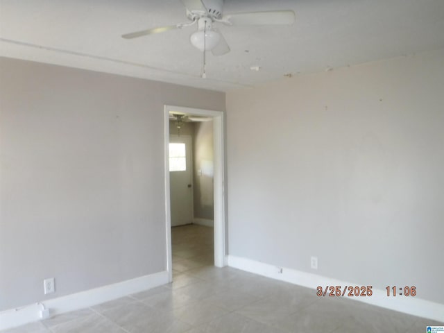 unfurnished room with baseboards and a ceiling fan