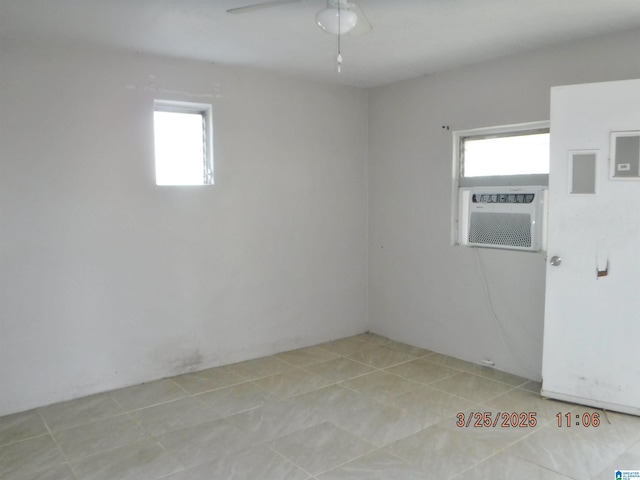 unfurnished room featuring light tile patterned flooring, a wealth of natural light, cooling unit, and a ceiling fan