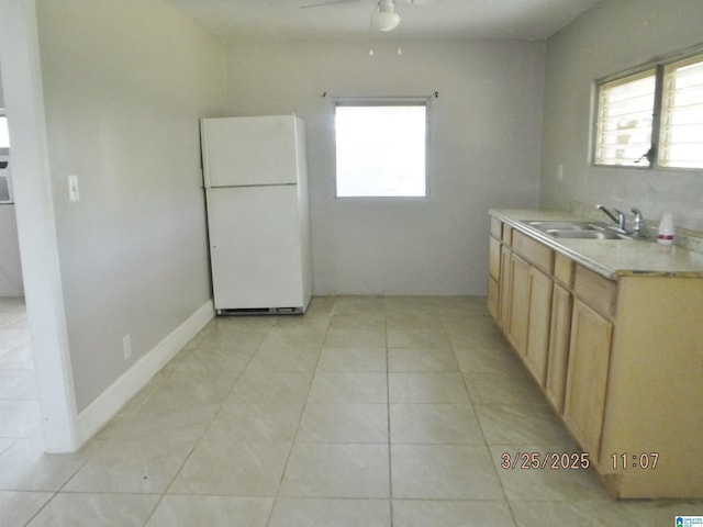 kitchen with freestanding refrigerator, light countertops, a healthy amount of sunlight, and ceiling fan