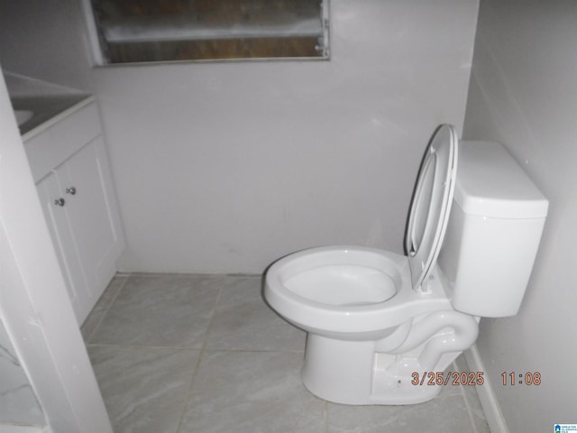 bathroom featuring tile patterned floors, toilet, and vanity