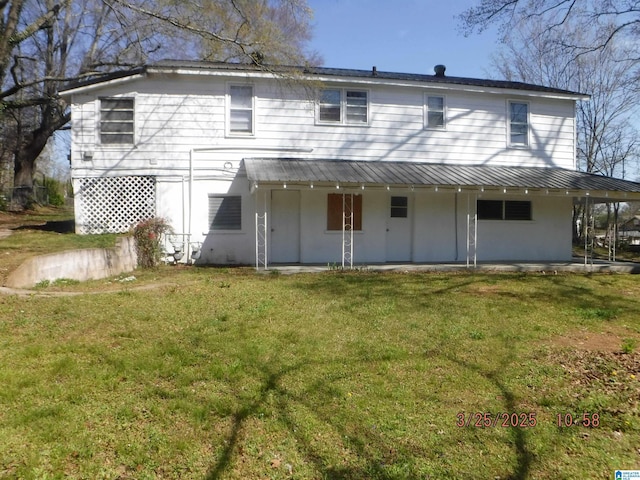 rear view of property with a lawn