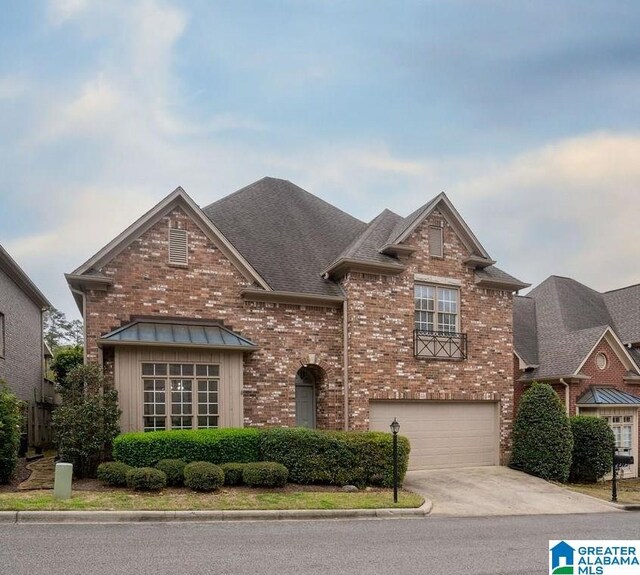 1595 Creekstone Cir, Birmingham, AL 35243 - traditional-style home with driveway, brick siding, an attached garage, and a shingled roof