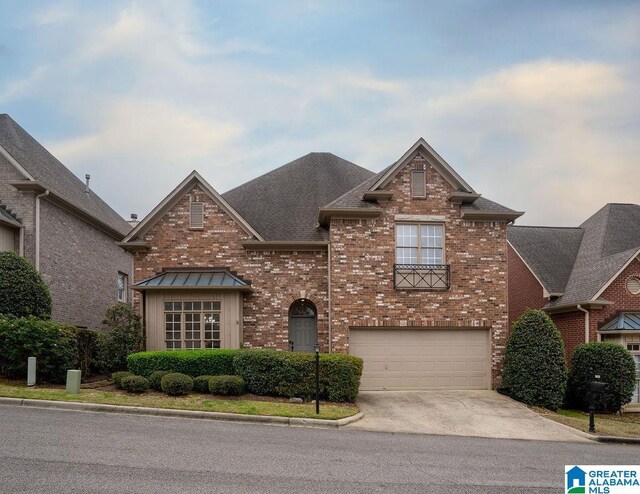 1595 Creekstone Cir, Birmingham, AL 35243 - traditional-style house with brick siding, driveway, a garage, and roof with shingles