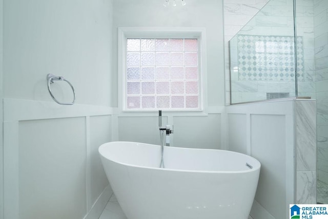 1595 Creekstone Cir, Birmingham, AL 35243 - full bathroom featuring a decorative wall, a soaking tub, wainscoting, and a tile shower