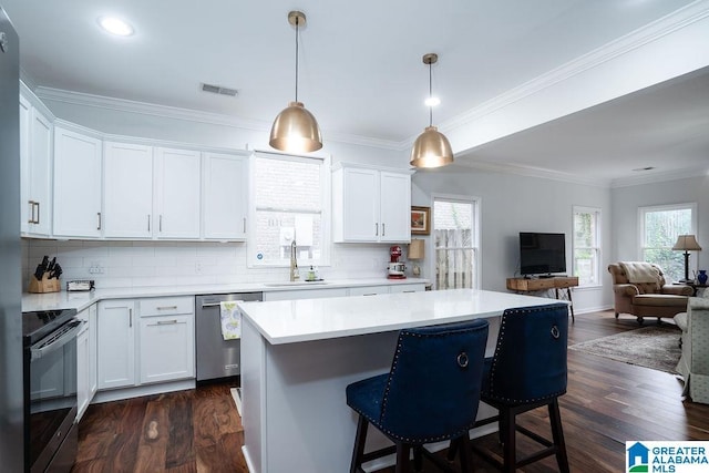 1595 Creekstone Cir, Birmingham, AL 35243 - kitchen with dishwasher, electric range, plenty of natural light, a breakfast bar, and ornamental molding