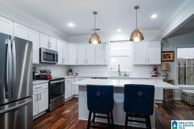 1595 Creekstone Cir, Birmingham, AL 35243 - kitchen with stainless steel appliances, a center island, light countertops, crown molding, and decorative backsplash