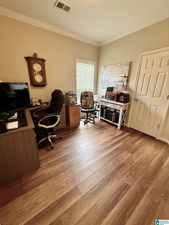 office area with visible vents, wood finished floors, and ornamental molding