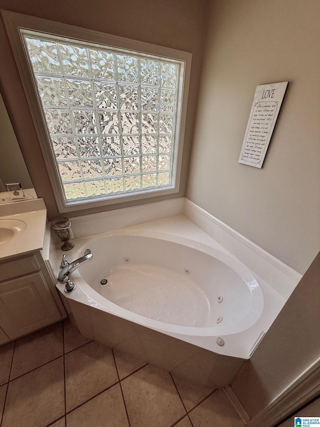 full bathroom featuring a tub with jets, tile patterned flooring, and vanity