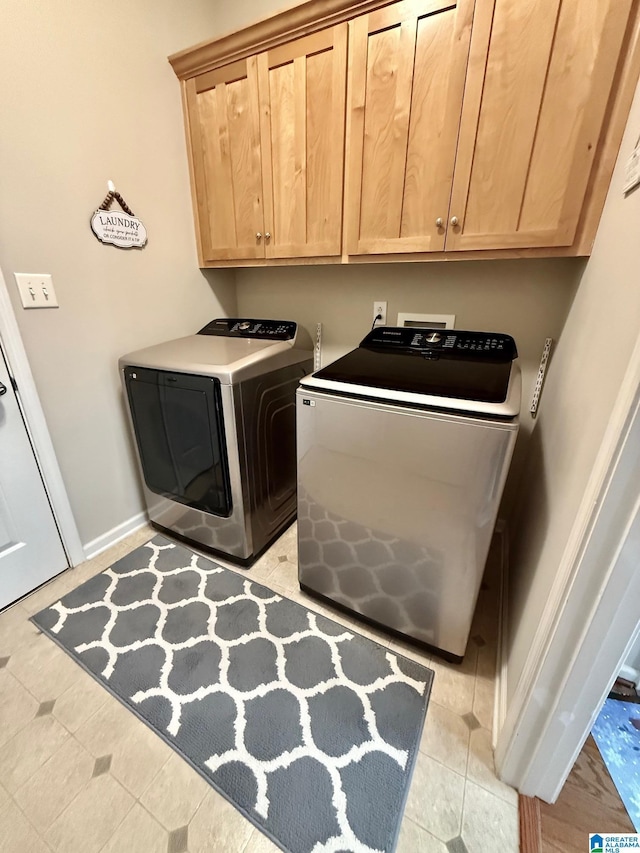 laundry room featuring cabinet space, baseboards, and separate washer and dryer