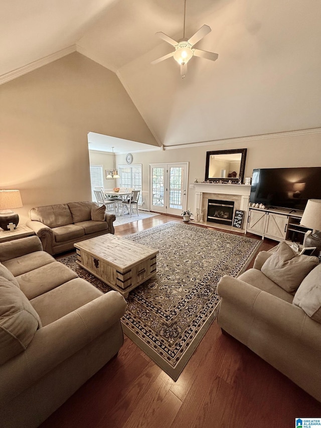 living room featuring a fireplace, high vaulted ceiling, ceiling fan, and wood finished floors