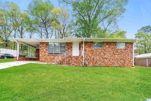 1625 Mann Dr, Birmingham, AL 35214 - ranch-style home featuring concrete driveway, fence, a front yard, brick siding, and an attached carport
