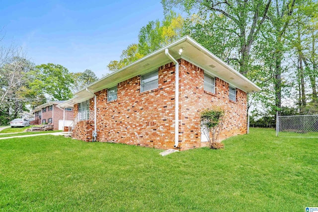 1625 Mann Dr, Birmingham, AL 35214 - view of side of property with a lawn, brick siding, and fence