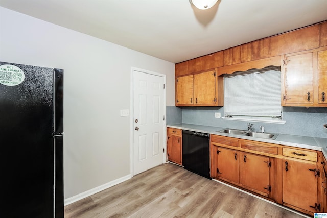 1625 Mann Dr, Birmingham, AL 35214 - kitchen featuring light countertops, light wood-style flooring, brown cabinets, a sink, and black appliances