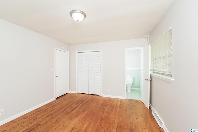 1625 Mann Dr, Birmingham, AL 35214 - unfurnished bedroom with light wood finished floors, baseboards, a closet, and connected bathroom