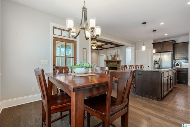 13147 Allison Dr, Lake View, AL 35111 - dining area with ceiling fan with notable chandelier, a fireplace, recessed lighting, wood finished floors, and baseboards