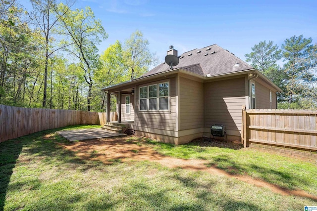 13147 Allison Dr, Lake View, AL 35111 - view of side of property with a shingled roof, a patio area, a lawn, a chimney, and a fenced backyard