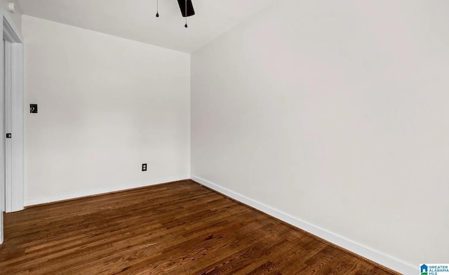 spare room featuring baseboards, a ceiling fan, and wood finished floors