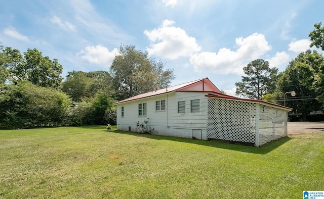 back of house with a lawn