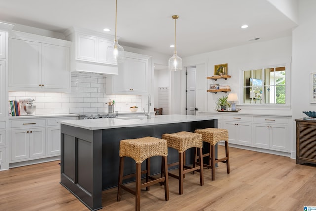 2505 Shore Side Ln, Sylacauga, AL 35151 - kitchen with white cabinets, light wood-style floors, light countertops, and a sink