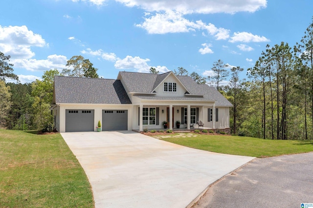 2505 Shore Side Ln, Sylacauga, AL 35151 - view of front of home featuring covered porch, roof with shingles, a front yard, a garage, and driveway