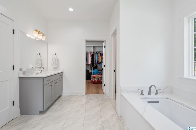 2505 Shore Side Ln, Sylacauga, AL 35151 - bathroom featuring a garden tub, vanity, plenty of natural light, and recessed lighting