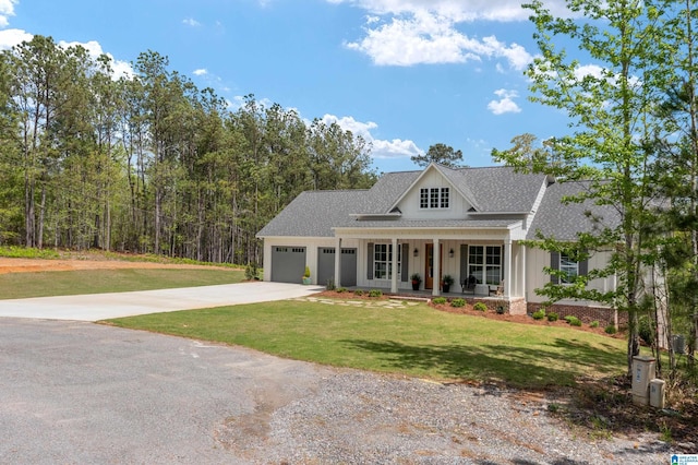 2505 Shore Side Ln, Sylacauga, AL 35151 - view of front facade with board and batten siding, covered porch, a front lawn, a garage, and concrete driveway