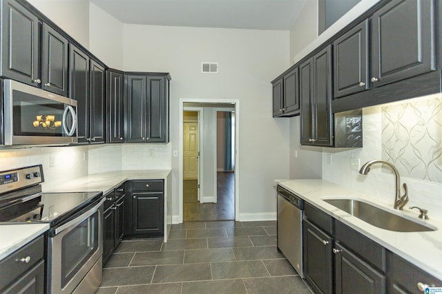 kitchen with visible vents, appliances with stainless steel finishes, light countertops, and a sink