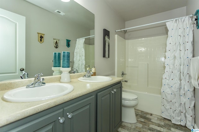 bathroom featuring shower / tub combo, double vanity, a sink, and visible vents