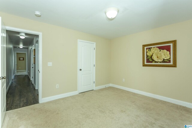 unfurnished bedroom featuring carpet flooring and baseboards