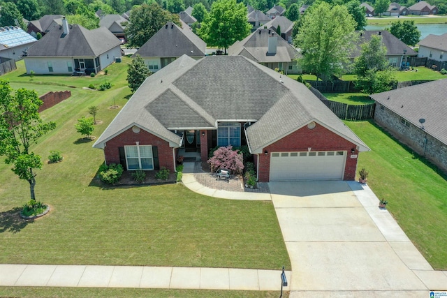 view of front of house featuring brick siding, driveway, an attached garage, and roof with shingles